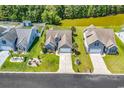 Aerial view of a home with a lush green lawn, beautiful landscaping, and a private backyard at 389 Barton Loop, Myrtle Beach, SC 29579