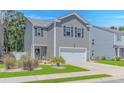 Charming gray two-story home with a two-car garage and landscaped front yard, presenting excellent curb appeal at 396 Emery Oak Dr., Murrells Inlet, SC 29576