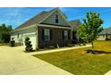 This home boasts dark brick with grey siding, a well manicured yard, and a two car garage at 4008 Tupelo Ct., Conway, SC 29526