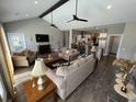 Spacious living room with vaulted ceilings, hardwood floors, comfortable seating, and an open floor plan at 4008 Tupelo Ct., Conway, SC 29526