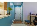 Welcoming entryway with a white door, stylish blue accent wall, and parquet flooring at 4276 Santolina Way # A, Murrells Inlet, SC 29576