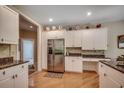 Open kitchen with stainless steel refrigerator, granite counters, hardwood floors and ample storage at 4363 Parkland Dr., Myrtle Beach, SC 29579