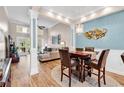 Open concept dining room showcasing modern lighting fixtures, wood floors, and plenty of space at 442 Mahogany Dr. # 101, Murrells Inlet, SC 29576