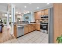 Open kitchen featuring stainless steel appliances, tile flooring, and natural wood cabinetry at 442 Mahogany Dr. # 101, Murrells Inlet, SC 29576