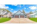 Beautiful light blue home featuring a wide driveway and a symmetrical two-car garage at 460 Boundary Ave. # A & B, Murrells Inlet, SC 29576