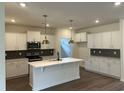 Modern kitchen features white cabinetry, stainless steel appliances, and a sleek island at 4762 Huckleberry Ln., Conway, SC 29526