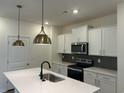 Kitchen boasts a large island, pendant lighting, and modern appliances at 4762 Huckleberry Ln., Conway, SC 29526