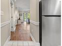 Hallway featuring wood floors leading to the living room, with stainless steel refrigerator in view at 4771 Wild Iris Dr. # 103, Myrtle Beach, SC 29577