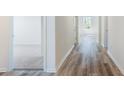 Bright hallway with wood floors leading to carpeted bedrooms with natural light at 492 Sun Colony Blvd., Longs, SC 29568