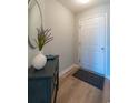Entryway with a wood floor, decorative mirror, cabinet and grey welcome mat at 5000 Windsor Green Way # 102, Myrtle Beach, SC 29579