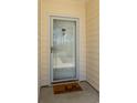 Close-up of the front door with glass screen, brass hardware, and 'hello' welcome mat at 5000 Windsor Green Way # 102, Myrtle Beach, SC 29579