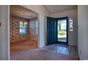 Inviting foyer with tile flooring and a view into a living space with floral wallpaper at 802 Mockingbird Ct., Murrells Inlet, SC 29576
