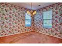 This living room features two windows and colorful floral wallpaper at 802 Mockingbird Ct., Murrells Inlet, SC 29576