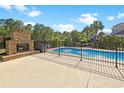 Outdoor fireplace, hot tub and in-ground pool with fountain feature, perfect for entertaining at 8029 Wacobee Dr., Myrtle Beach, SC 29579