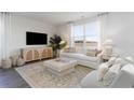 Cozy living room with plush seating, neutral decor, and lots of natural light at 858 Farmers Passage Loop, Loris, SC 29569