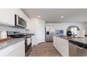 Well-equipped kitchen featuring white cabinets, granite countertops, and stainless steel appliances at 862 Farmers Passage Loop, Loris, SC 29569
