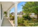 A cozy front porch with views of a well-kept neighborhood and lush greenery at 908 Oglethorpe Dr., Conway, SC 29527