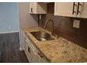 New kitchen featuring granite countertops, stainless steel sink, and stylish brown tile backsplash at 950 Forestbrook Rd. # C3, Myrtle Beach, SC 29579