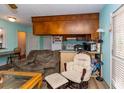 A comfortable living room area with a sofa, chair, rocker, and access to the kitchen through a bar height pass through at 106 Azalea Dr., Conway, SC 29526