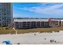 Beachfront condo exterior shot featuring balconies and complex pool at 108 N Ocean Blvd. # 308, North Myrtle Beach, SC 29582