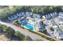 Aerial view showcasing the condo complex, pool, lush trees, and surrounding area at 10970 Highway 90 # A5, Little River, SC 29566