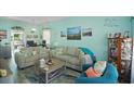 Cozy living room with a nautical design, comfortable seating, and coastal artwork at 10970 Highway 90 # A5, Little River, SC 29566