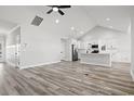 Spacious, light-filled living area flows into a kitchen with modern appliances and wood flooring at 1127 Crooked Hook Rd., North Myrtle Beach, SC 29582