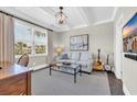 Cozy living room with a plush sofa, a glass coffee table, bright windows, and neutral walls at 1136 Doubloon Dr., North Myrtle Beach, SC 29582