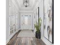 Inviting foyer featuring a decorative front door, trey ceiling, sleek flooring, and elegant decor at 1196 Fiddlehead Way, Myrtle Beach, SC 29579