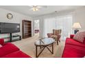 Cozy living room with bright natural light, ceiling fan and comfortable seating arrangement at 138 Butkus Dr. # 2, Myrtle Beach, SC 29588