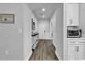 Inviting hallway featuring wood floors, white trim, and tasteful decor at 1463 Villena Dr., Myrtle Beach, SC 29579