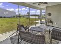 The screened-in patio offers a serene outdoor space with lake view at 1463 Villena Dr., Myrtle Beach, SC 29579