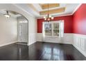 Inviting dining room with dark hardwood floors, elegant wainscoting, and modern chandelier at 1800 Wood Stork Dr., Conway, SC 29526
