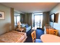 Cozy suite with a sleeper sofa, sitting area, television and private balcony at 201 77Th Ave. N # 828, Myrtle Beach, SC 29572
