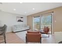 Bright living room with sliding glass doors to balcony and comfortable seating at 205 Double Eagle Dr. # C-2, Myrtle Beach, SC 29575