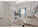 Efficient kitchen layout with white appliances and cabinets, showcasing a functional and clean design at 2090 Cross Gate Blvd. # 205, Surfside Beach, SC 29575