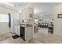Cozy kitchen with white cabinets and appliances, open to the living room, creating a welcoming atmosphere at 2090 Cross Gate Blvd. # 205, Surfside Beach, SC 29575