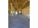 The interior of a house under construction with exposed wooden frames and a concrete floor at 2186 Mineral Springs Rd., Conway, SC 29527