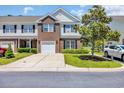 Charming townhome exterior featuring brick accents, black shutters, and well-maintained landscaping at 260 Connemara Dr. # E, Myrtle Beach, SC 29579