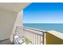 Relaxing balcony view overlooking the beach with clear blue skies and provided seating at 2701 S Ocean Blvd. # 1603, North Myrtle Beach, SC 29582