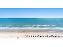 Expansive beach view highlighting the ocean, sand, beach umbrellas, and clear blue sky at 2701 S Ocean Blvd. # 1603, North Myrtle Beach, SC 29582