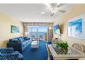 Cozy living room with a large window, comfortable seating, ceiling fan, and a dining area at 2701 S Ocean Blvd. # 1603, North Myrtle Beach, SC 29582