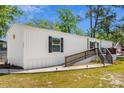 Well-kept mobile home with an inviting wooden porch and walkway, set on a manicured lawn at 2706 Willow St., North Myrtle Beach, SC 29582