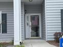 A welcoming condo entrance adorned with the American flag on the door at 307 Black Oak Ln. # 102, Murrells Inlet, SC 29576