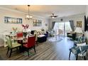Living room with modern coastal decor, luxury vinyl floors, and sliding door to balcony at 3979 Forsythia Ct. # 203, Myrtle Beach, SC 29588