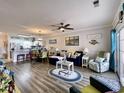 Bright living room flows into the kitchen area, featuring luxury vinyl flooring and coastal decor at 3979 Forsythia Ct. # 203, Myrtle Beach, SC 29588