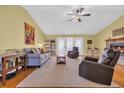 Spacious living room with hardwood floors, fireplace, gray sofa, and neutral area rug at 4104 Friendfield Trace, Little River, SC 29566
