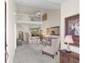 Bright, open-concept living room featuring high ceilings, a loft, and an adjoining staircase at 432 Warrington Way # 432, Murrells Inlet, SC 29576