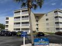 Image shows the exterior of the building with a sign and parking in front at 4350 Intercoastal Dr. # 2302, Little River, SC 29566