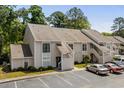 Two-story condo building exterior showcasing the facade with stairwell access and parking area at 4470 Little River Inn Ln. # 1005, Little River, SC 29566